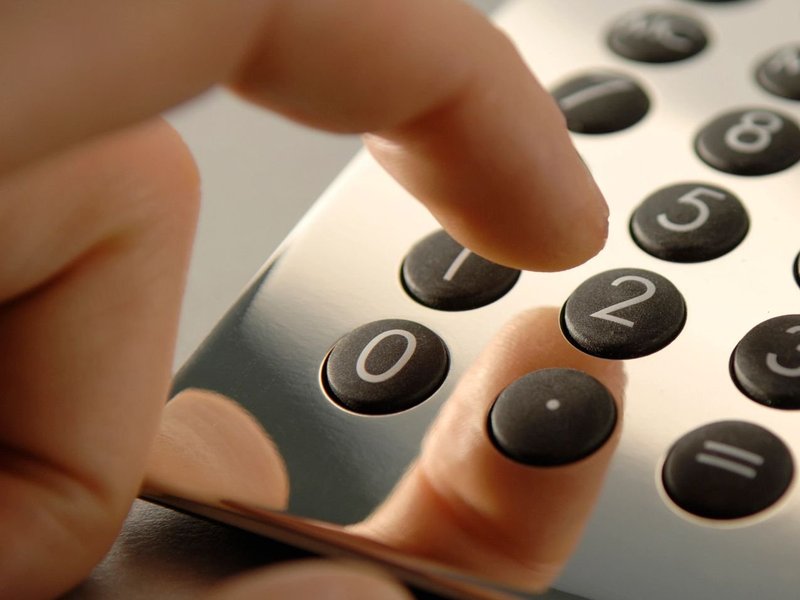 person using calculator. Finance options from Pritchett's Flooring Design Center in the Colonial Heights, VA area