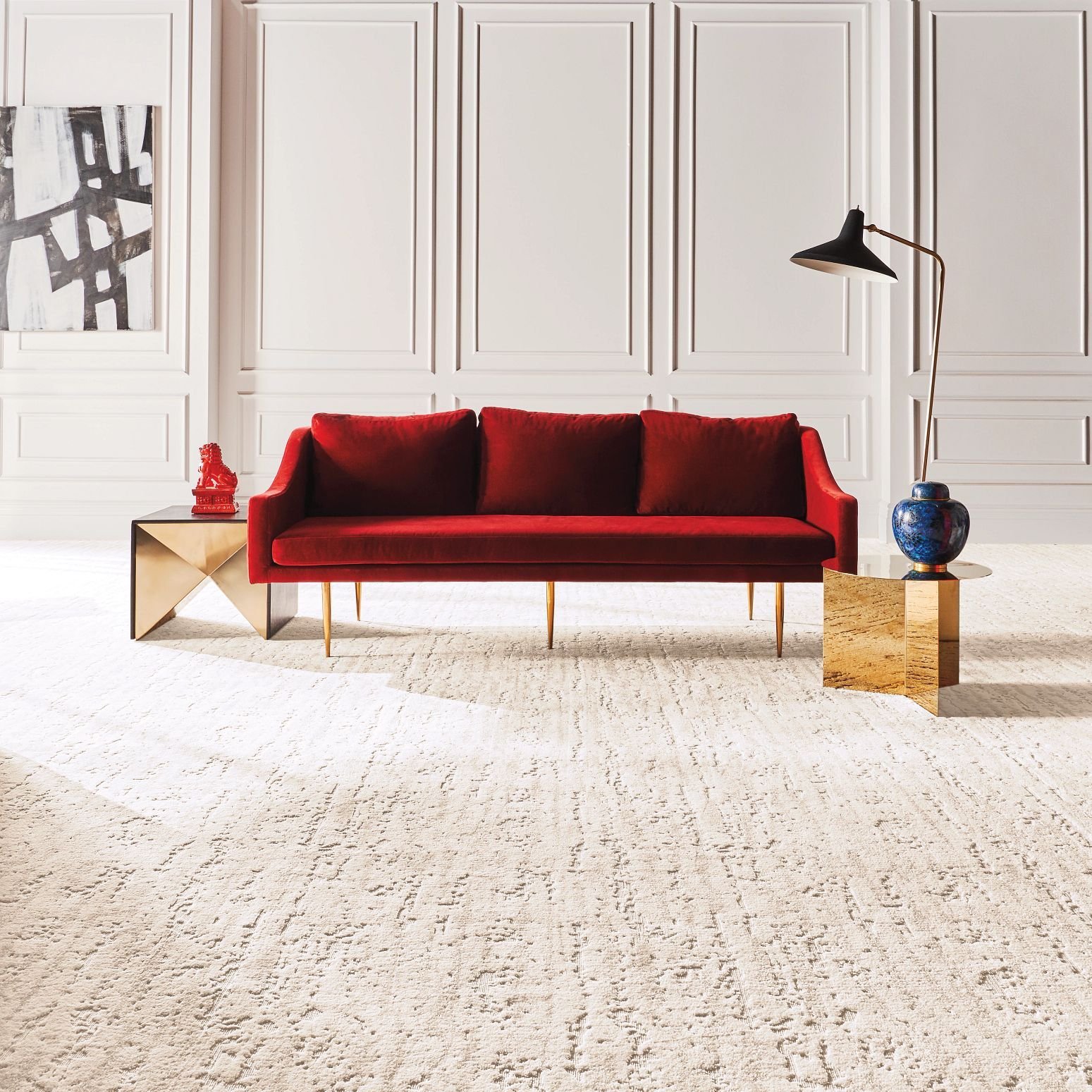 bright living room with a red velvet couch and cream colored textured carpet from Pritchett's Flooring Design Center in the Colonial Heights, VA area